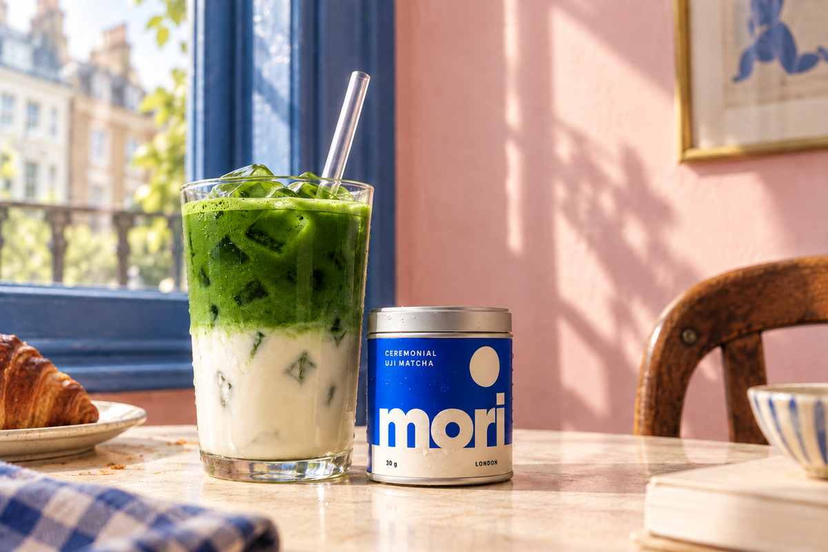 London café iced matcha latte with a rich emerald matcha layer and Mori tin