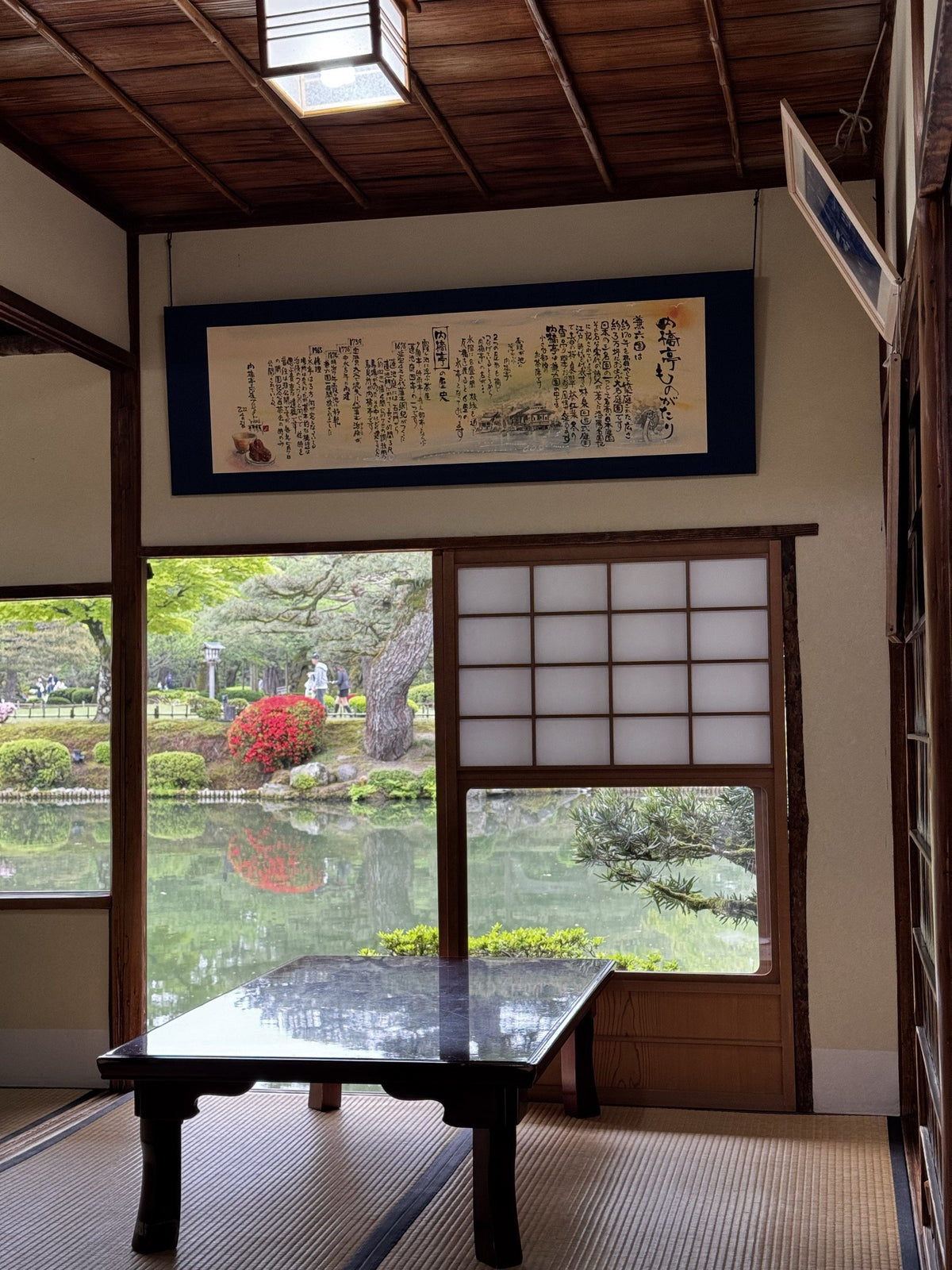 A traditional tea house overlooking a garden pond